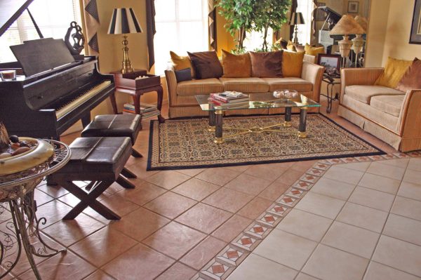 a rustic living room with ceramic tiles and furniture