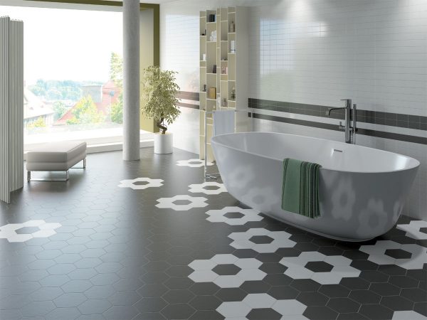 A modern bathroom featuring a soaking tub and hexagonal shaped floor tiles