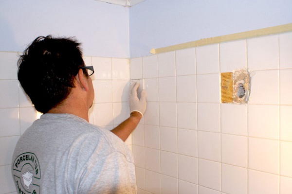 A man installing tiles