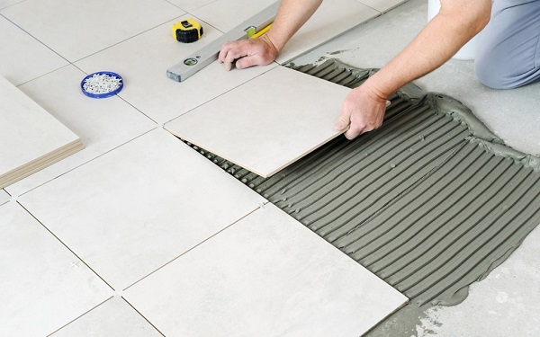 A person installing tiles