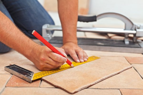 A person repairing a tile