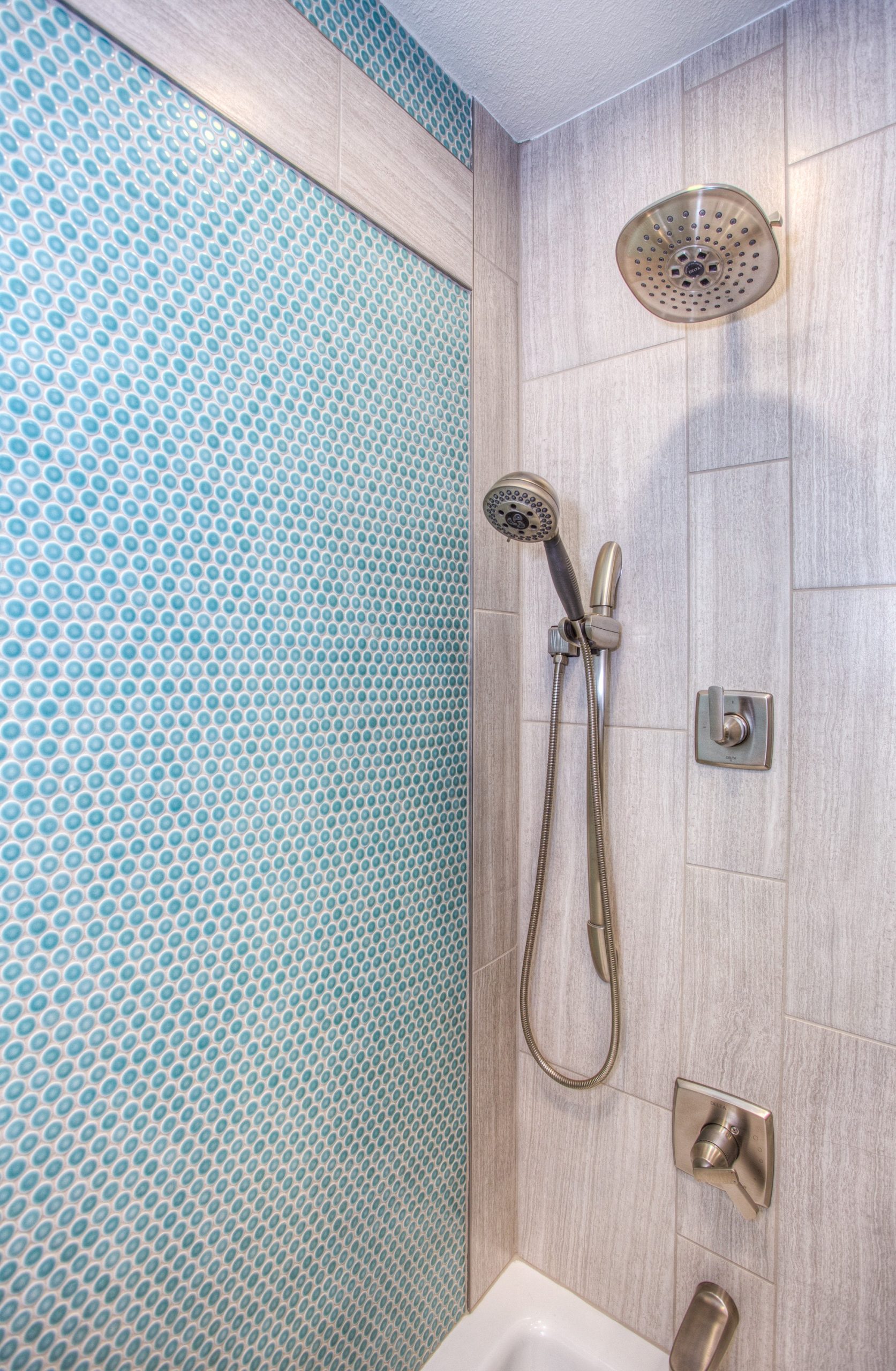 a shower that has tiles as one of the walls