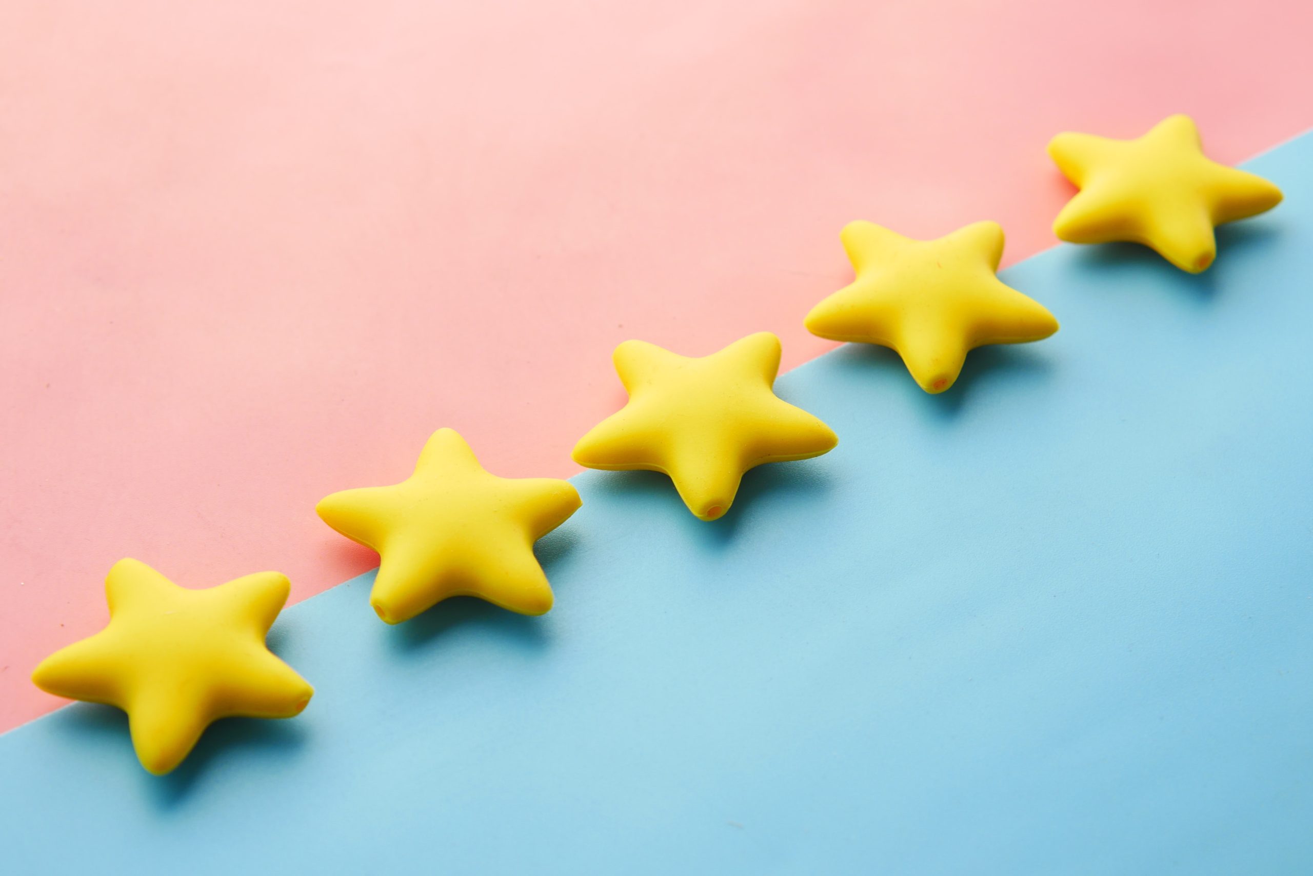 a blue and pink background with yellow stars