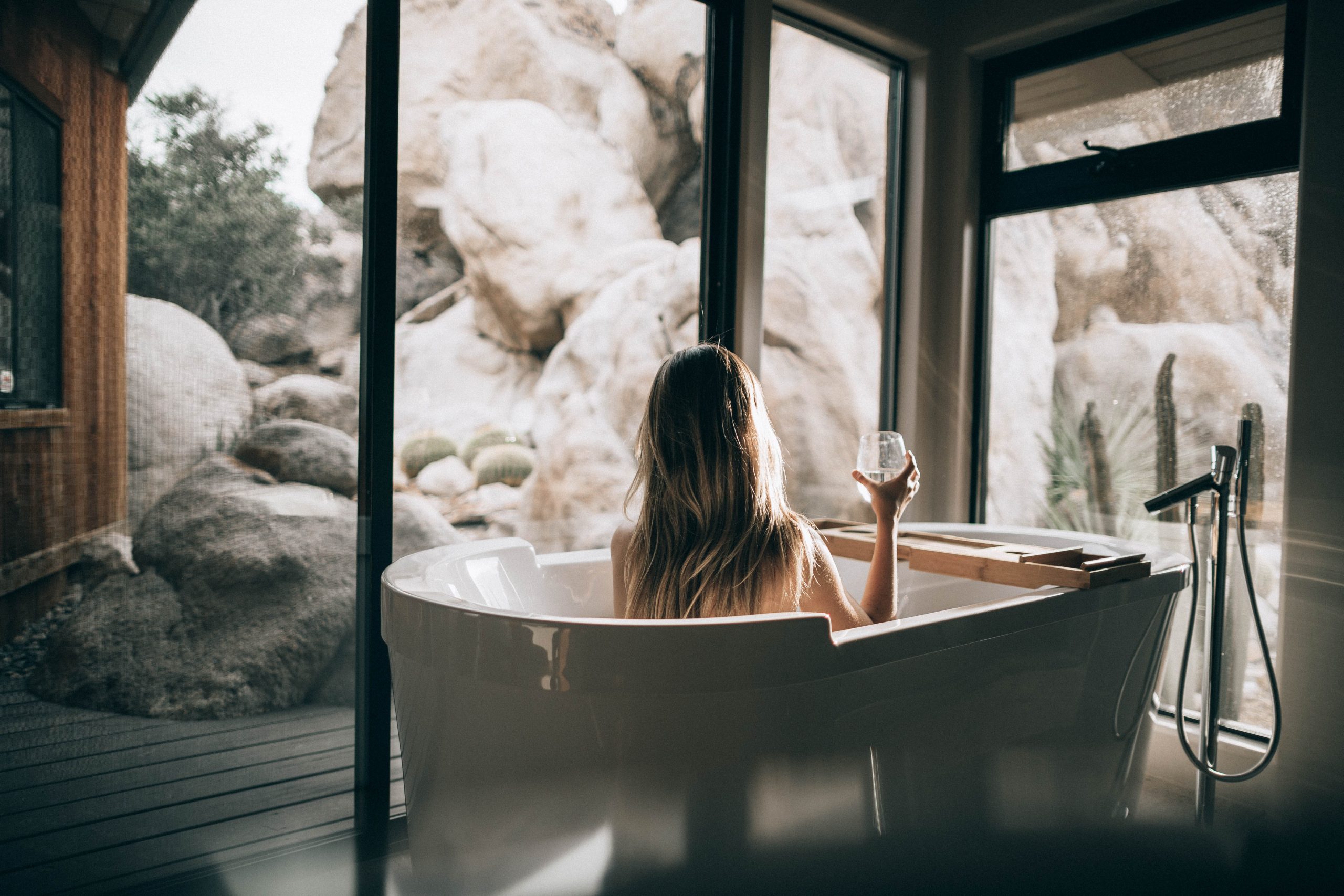 A women sitting in a bath tub with bubbles